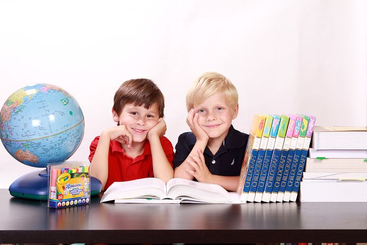 child care center with 2 boys, a globe and books